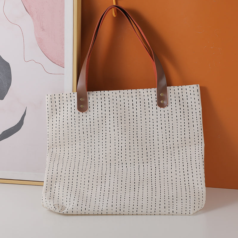 Simple geometric shopping bag with leather shoulder strap